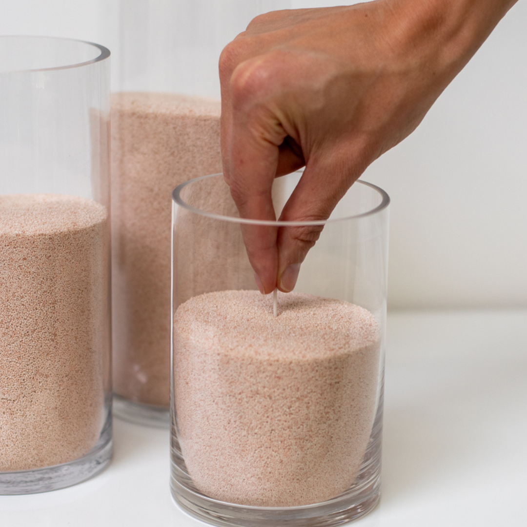 2. Insert and light the wick