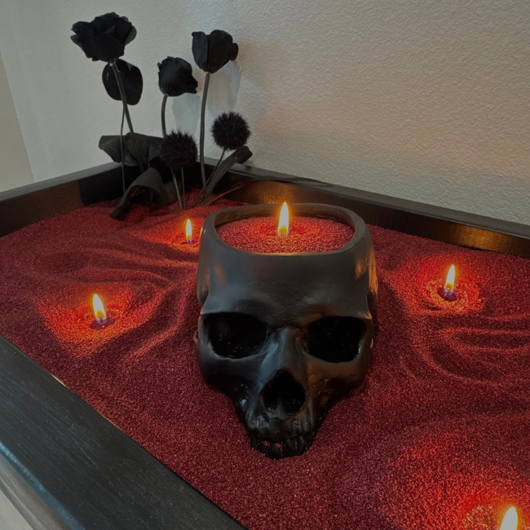 Gothic Halloween centerpiece with maroon Foton Pearled Candles, a black skull candle, and black roses in a decorative tray.