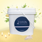 A vibrant, scent-forward product image showcasing the 144oz Foton pearled candle packaging against a fresh, citrus-inspired backdrop. Bursting with botanical elements and dynamic splashes, the scene highlights the fragrance profile while the glowing wicks, textured wax and a scoop ground the product in warmth and sensory appeal.