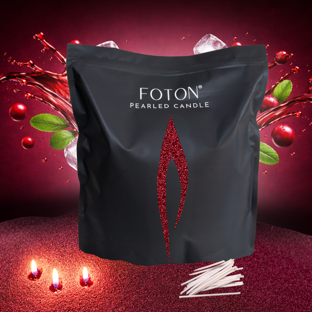 Black Foton Pearled Candle grance bag displayed against a bold red background with splashing cranberry juice, cranberries, mint leaves, and ice cubes, with cotton wicks and glowing maroon candle flames in the foreground.