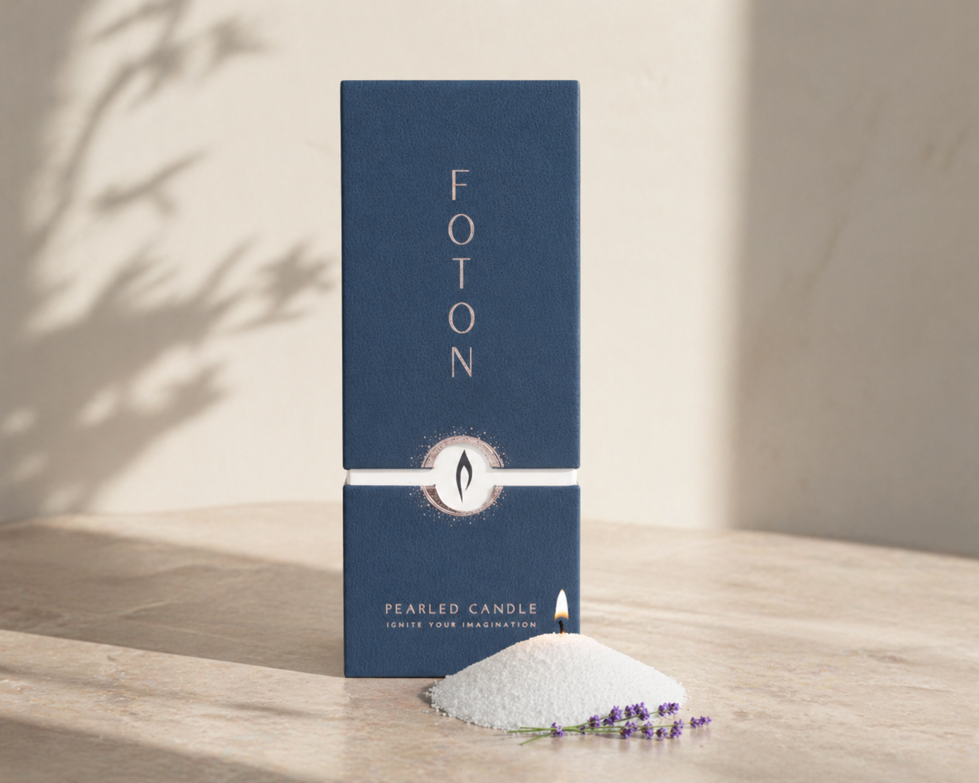 Blue 18oz Foton Pearled Candle box standing on a neutral surface beside a small mound of white wax pearls with a lit wick and lavender sprig, styled with soft natural lighting and shadows.