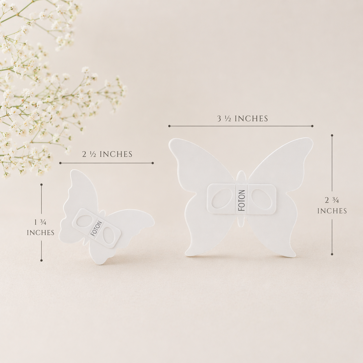 Product detail image of Foton butterfly stencils, showcasing two size options with clearly labeled dimensions: a larger stencil measuring approximately 3.5 inches wide by 2¾ inches tall, and a smaller stencil measuring about 2.5 inches wide by 1¾ inches tall. The stencils are designed for creating decorative surface patterns on pearled candles, highlighting easy customization in a clean, natural setting.