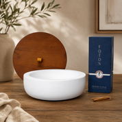 White Luxe Concrete Bowl with a wooden lid, Foton pearled candle box, and wooden wicks arranged on a wooden table in a bright, minimalist setting. The image highlights everything included with the outdoor candle set.
