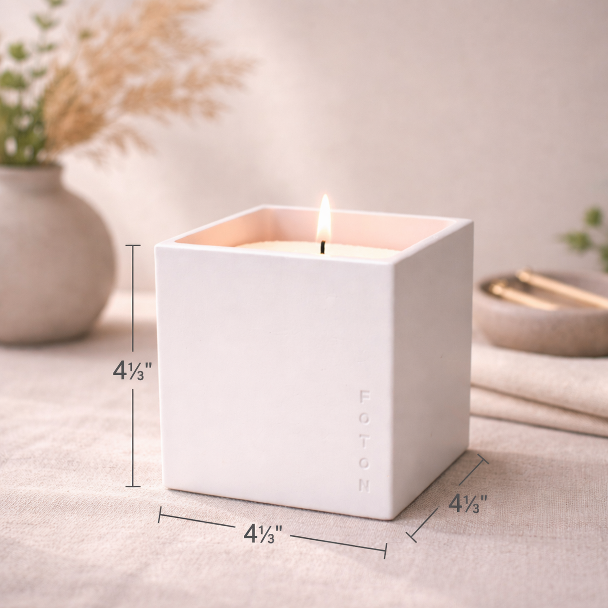 Product image showing the Foton square concrete candle vessel with wooden lid, featuring dimensions of 4⅓ inches in height, width, and depth.