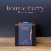 Product image of the Bougie Berry candle in the Le Cube vessel, presented in premium packaging with deep, rich tones to reflect its berries and cream scent profile.