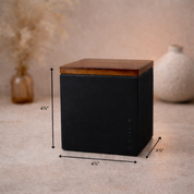 Product image showing the Foton square concrete candle vessel with wooden lid, featuring dimensions of 4⅓ inches in height, width, and depth.
