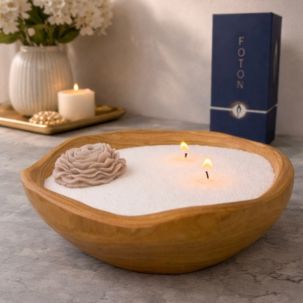 Lifestyle image showcasing a handcrafted wood bowl candle filled with pearled wax, featuring multiple lit wicks and a decorative wax flower accent, styled in a soft, elegant home setting with subtle background decor and Foton packaging to highlight a refined, gift-ready experience.