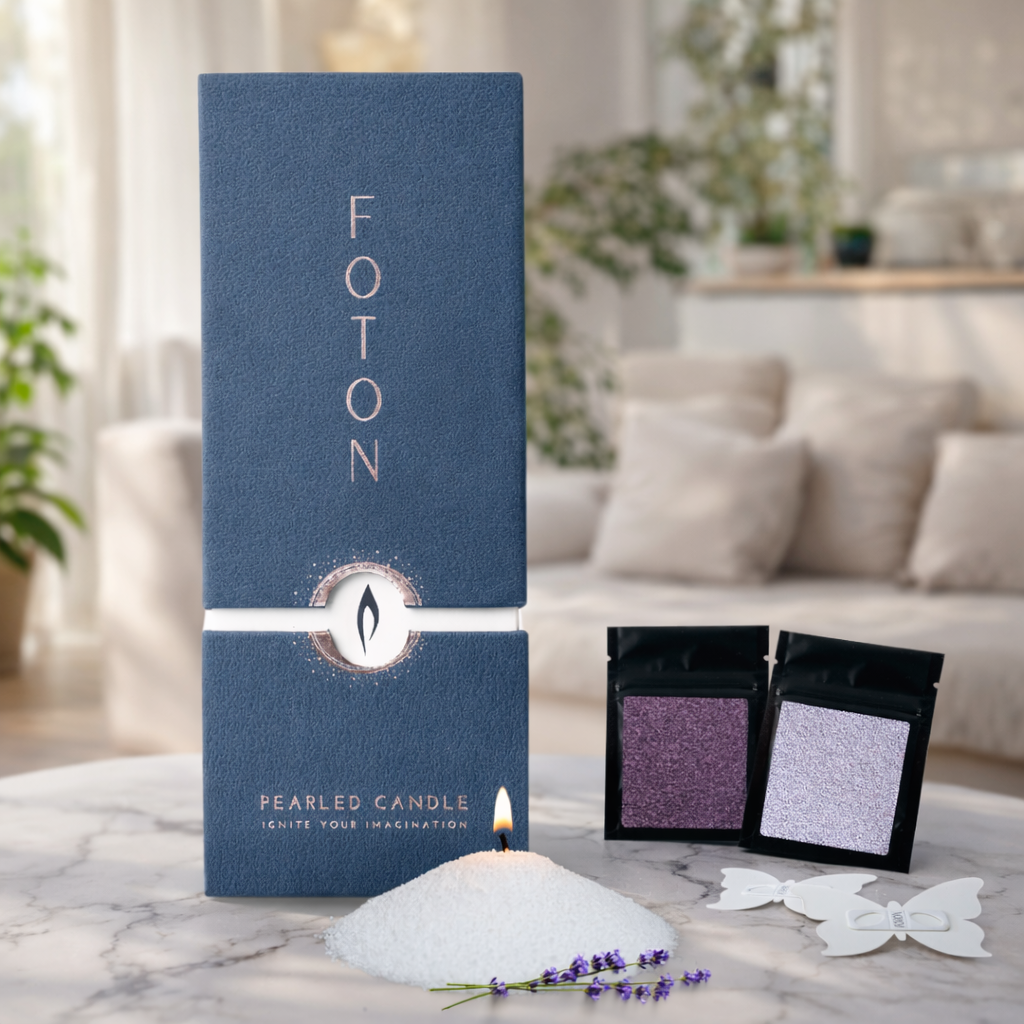 Product display of the Foton pearled candle gift box alongside color sample pouches, butterfly stencil, and loose candle pearls with a lit wick, highlighting a customizable, build-your-own candle experience.
