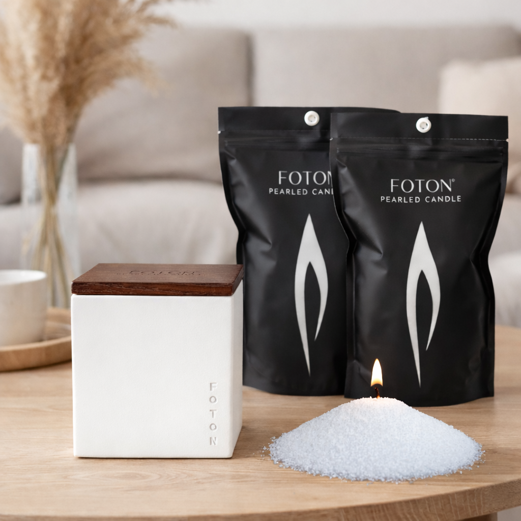 Product display featuring Foton pearled candle refill bags, a minimalist candle vessel with wooden lid, and loose candle pearls with a lit wick, emphasizing a clean, refillable, and modern candle system.