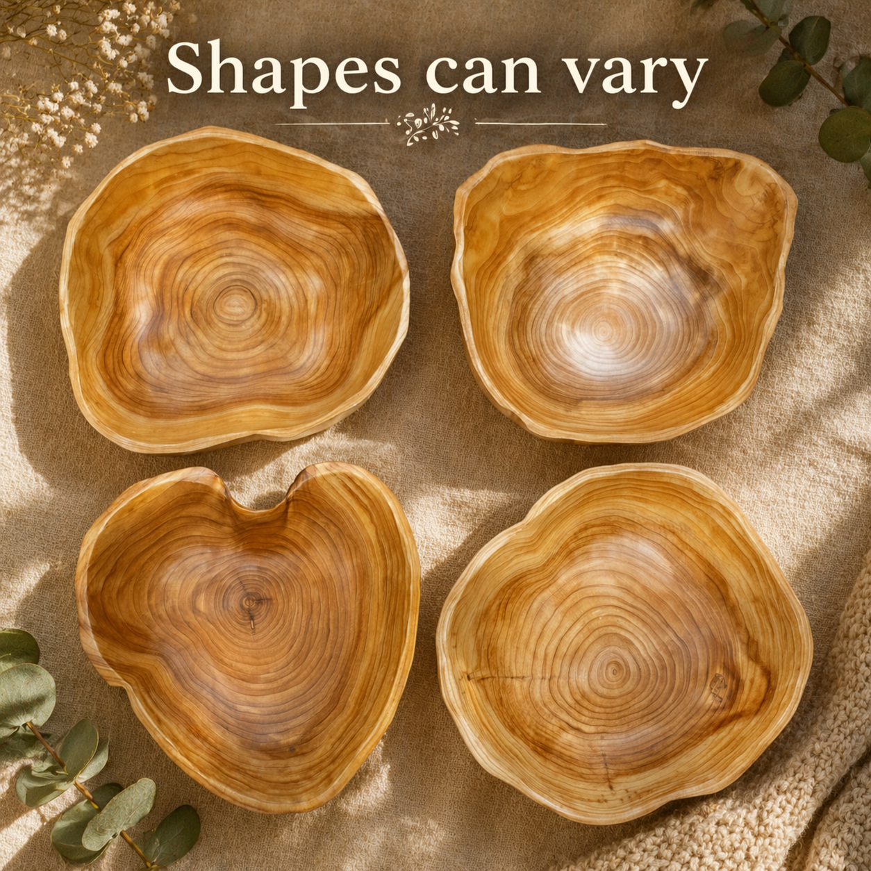 A warm, lifestyle product image showcasing a variety of handcrafted wooden bowls, each with its own unique organic shape and natural grain pattern. The composition highlights the individuality of each piece, reinforcing that shapes can vary, while soft lighting and earthy textures create a calm, artisanal aesthetic.